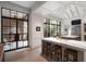 The kitchen boasts an island with seating, stainless steel appliances, and access to outdoor spaces for dining and entertainment at 55 E Bay St, Charleston, SC 29401