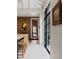 Bright kitchen with exposed brick wall, seating at island and doorway to other rooms at 55 E Bay St, Charleston, SC 29401