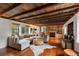 Bright living room features reclaimed wood ceiling, fireplace, and large sectional sofa at 55 E Bay St, Charleston, SC 29401