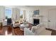 Cozy living room with fireplace, white furniture, and hardwood flooring at 55 E Bay St, Charleston, SC 29401