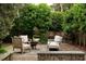 Inviting outdoor patio featuring a fire pit, comfortable seating, and privacy landscaping at 55 E Bay St, Charleston, SC 29401