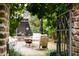 Beautiful outdoor patio with a fire pit, seating, and a wrought iron gate at 55 E Bay St, Charleston, SC 29401