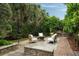 Charming outdoor patio with a cozy seating area, brick accents, and lush landscaping at 55 E Bay St, Charleston, SC 29401