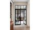 Elegant patio with black steel-framed glass doors and furniture provides a great area for outdoor dining and relaxation at 55 E Bay St, Charleston, SC 29401