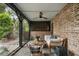 Relaxing porch features brick wall, wood-beamed ceiling and comfortable seating at 55 E Bay St, Charleston, SC 29401