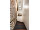 Staircase with wooden stairs and exposed brick wall, illuminated by a pendant light at 55 E Bay St, Charleston, SC 29401