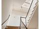 Bright staircase with white and dark wood banister with detailed trim to the upper floors at 55 E Bay St, Charleston, SC 29401