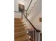 Classic staircase design with neutral carpet runner, white balusters, and dark wood handrail, creating an inviting entrance at 55 E Bay St, Charleston, SC 29401