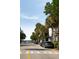 Picturesque street view with palm trees, parked cars, and charming homes under a clear blue sky at 55 E Bay St, Charleston, SC 29401
