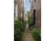 Walkway features a brick path with an iron gate leading to lush landscaping at 55 E Bay St, Charleston, SC 29401