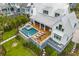 Aerial view of a home's backyard with a pool, hot tub, outdoor seating area, and lush greenery at 553 Old Compass Rd, Daniel Island, SC 29492