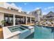 Stunning backyard oasis featuring a pool, hot tub, and covered patio with ample seating, perfect for entertaining at 553 Old Compass Rd, Daniel Island, SC 29492