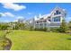 Expansive backyard with lush green grass, mature landscaping, and serene waterfront views at 553 Old Compass Rd, Daniel Island, SC 29492