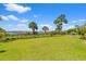 Beautifully landscaped backyard with a metal fence offering stunning views of the water at 553 Old Compass Rd, Daniel Island, SC 29492