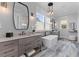 Modern bathroom with freestanding tub, double vanities, and unique lighting fixtures at 553 Old Compass Rd, Daniel Island, SC 29492