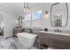 Bright bathroom with freestanding tub, double vanities, and decorative hanging lighting at 553 Old Compass Rd, Daniel Island, SC 29492