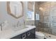 Stylish bathroom with a patterned tile shower, modern vanity, and hexagon-shaped mirror at 553 Old Compass Rd, Daniel Island, SC 29492