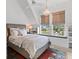 Bright bedroom featuring a chandelier, large windows, and a comfortable bed with white linens at 553 Old Compass Rd, Daniel Island, SC 29492
