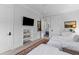 Bright bedroom featuring twin beds, an artful rug, a TV, and a hallway leading to another room at 553 Old Compass Rd, Daniel Island, SC 29492