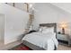 Cozy bedroom with white linens, stairs to upper floor, and a nightstand lamp at 553 Old Compass Rd, Daniel Island, SC 29492