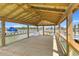 Spacious wooden covered deck with waterfront views, perfect for relaxing or entertaining at 553 Old Compass Rd, Daniel Island, SC 29492