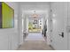 Inviting foyer with light wood floors and a view to the home's outdoor space at 553 Old Compass Rd, Daniel Island, SC 29492