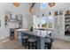 Modern kitchen featuring a large island with seating, stainless steel appliances, and ample natural light at 553 Old Compass Rd, Daniel Island, SC 29492