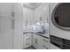 Well-organized laundry room with modern washer/dryer and black hardware and backsplash at 553 Old Compass Rd, Daniel Island, SC 29492