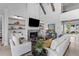 Bright living room with fireplace, wood beams, built-in shelves, and lots of natural light at 553 Old Compass Rd, Daniel Island, SC 29492