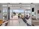 Bright living room featuring a seamless indoor-outdoor connection, with views of the waterfront and pool at 553 Old Compass Rd, Daniel Island, SC 29492