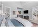 Main bedroom with ensuite bathroom access, a TV, and attractive decor at 553 Old Compass Rd, Daniel Island, SC 29492