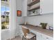 Bright home office featuring custom cabinetry and a beautiful wood desk at 553 Old Compass Rd, Daniel Island, SC 29492