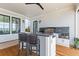 Covered outdoor kitchen with bar seating, granite countertop, grill, and views at 553 Old Compass Rd, Daniel Island, SC 29492