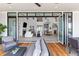 Inviting outdoor living space with comfortable seating, wood deck, and bi-fold doors opening to interior at 553 Old Compass Rd, Daniel Island, SC 29492