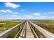 Scenic view of a long wooden pier leading to the water with a clear blue sky at 553 Old Compass Rd, Daniel Island, SC 29492