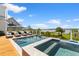 Luxury pool and spa area with lounge chairs and stunning views of the water and sky at 553 Old Compass Rd, Daniel Island, SC 29492