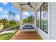 Inviting porch with wood flooring, a swing, and beautiful views of the surrounding landscape at 553 Old Compass Rd, Daniel Island, SC 29492