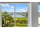 Scenic waterfront view from a window, showcasing a serene bay with docks and lush greenery at 553 Old Compass Rd, Daniel Island, SC 29492