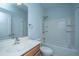 Bright bathroom featuring a shower-over-tub and vanity sink with a full mirror and white tiled shower at 765 Certificate Ct, Charleston, SC 29414