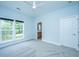Bright bedroom with ceiling fan, plush carpet, and large windows offering natural light at 765 Certificate Ct, Charleston, SC 29414