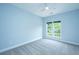 Empty carpeted bedroom with large window offering natural light and a ceiling fan at 765 Certificate Ct, Charleston, SC 29414