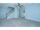 Carpeted bedroom featuring stairs, ceiling fan and a doorway with an open room at 765 Certificate Ct, Charleston, SC 29414