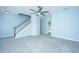 Bedroom with carpet, ceiling fan, and stairs visible plus an open doorway to another room at 765 Certificate Ct, Charleston, SC 29414