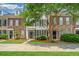 Townhouse style home exterior with lush landscaping, a brick facade, and a well-manicured lawn at 765 Certificate Ct, Charleston, SC 29414