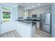 Bright kitchen featuring granite countertops, stainless appliances, and access to backyard at 765 Certificate Ct, Charleston, SC 29414