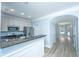 Kitchen with granite countertop, stainless steel appliances, and white cabinetry open to living room at 765 Certificate Ct, Charleston, SC 29414