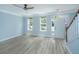 Inviting living room featuring light blue walls, wood-look flooring, and abundant natural light from windows at 765 Certificate Ct, Charleston, SC 29414