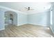 Bright living room with light blue walls, light wood floors, ceiling fan and archway to kitchen at 765 Certificate Ct, Charleston, SC 29414