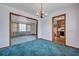 Dining room with chandelier, wood trim, carpet, and open view to kitchen at 7659 Allwood Ave, North Charleston, SC 29418