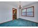 Dining room with chandelier, wood trim window, carpet, and open doorway to kitchen at 7659 Allwood Ave, North Charleston, SC 29418